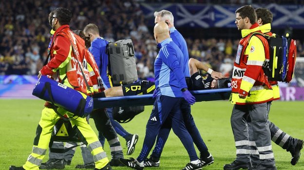 Кирана Тирни уносят на носилках во время матча со Швейцарией.