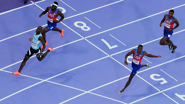 Ноа Лайлс (внизу) финиширует третьим в забеге на 200 метров.