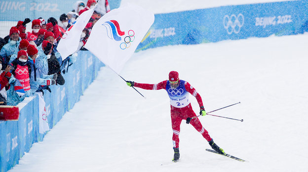 Сергей Устюгов. Сергей Устюгов финиш с флагом на XXIV зимних Олимпийских играх 2022