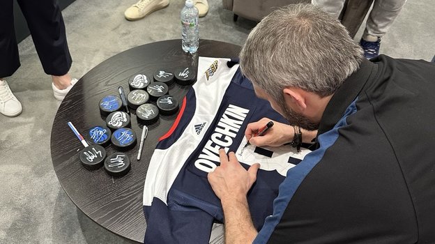 Александр Овечкин подписывает свой свитер для болельщиков «Динамо».