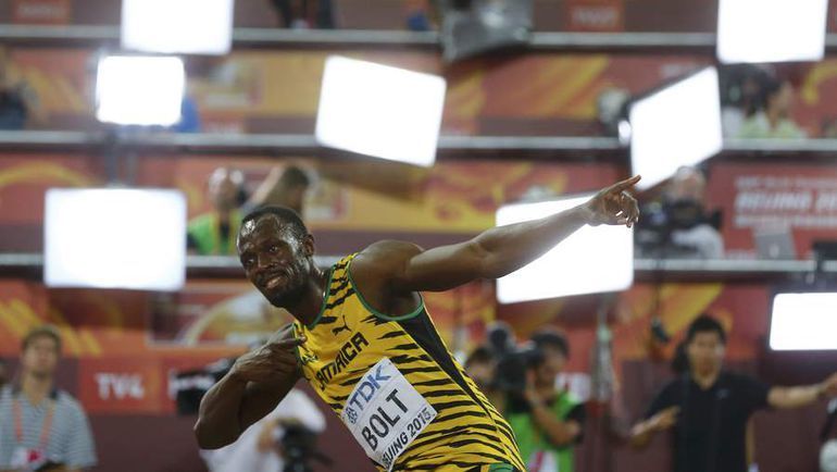 Усэйн БОЛТ и его фирменный жест. Фото AFP Усэйн БОЛТ и его фирменный жест. Фото AFP